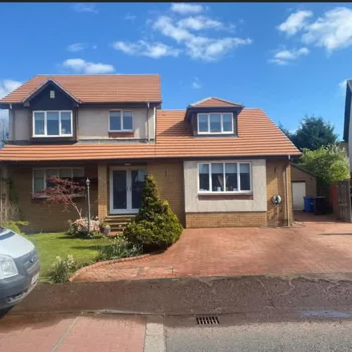 House with a newly laid terracotta tiled roof over the main roof and dormer