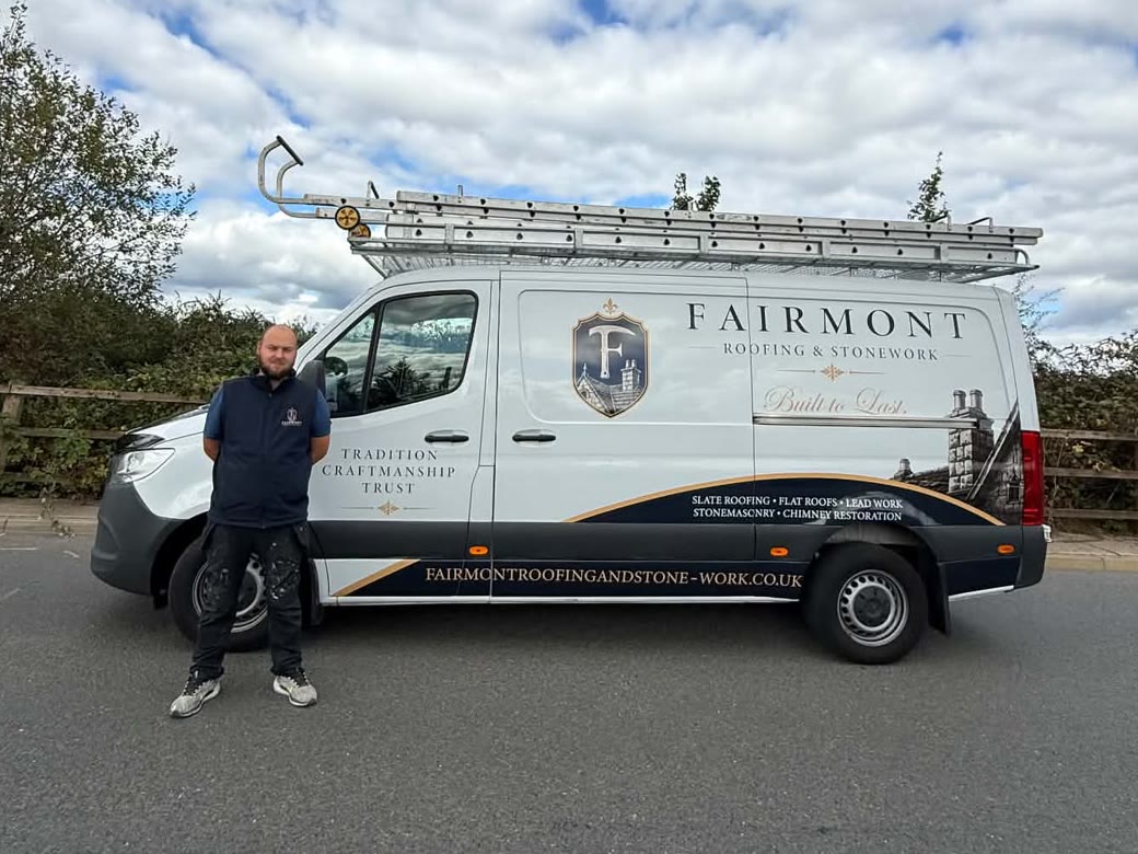 Sean McPherson standing beside the Fairmont Roofing and Stonework van